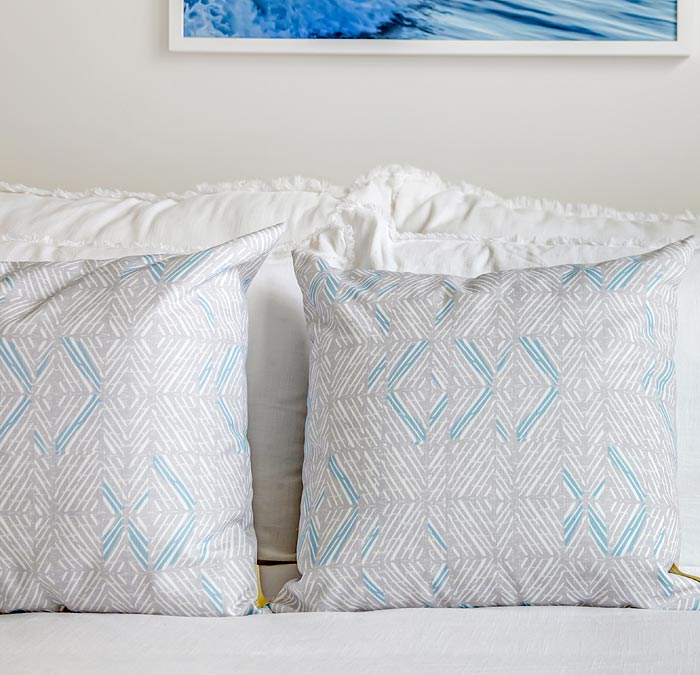 Contract Hawaiian Design Products Pillowcases On a Bed With Tan and Light Blue Hawaiian Motif