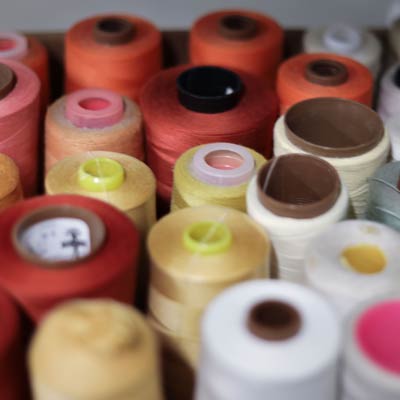 Spools Of Colorful Thread Rolls Showcasing Custom Design Services