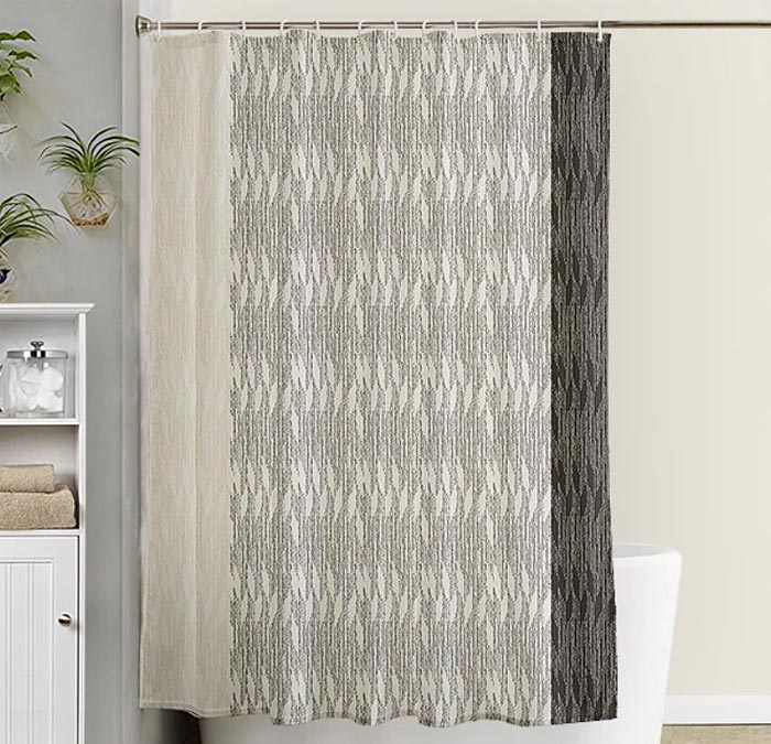 Tan and Brown Contract Hawaiian Print Shower Curtain Hanging Above a Standing Tub